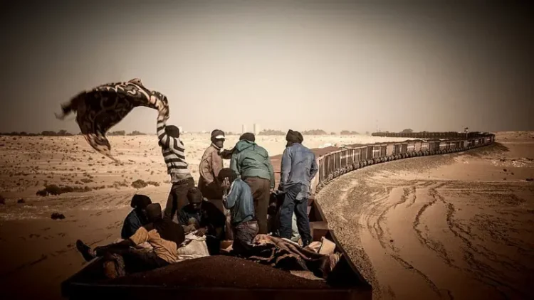 Such trips are commonplace for many Mauritanians. In 2014, British photographer Michal Huniewicz took a trip on a train loaded with ore. He took his pictures sitting on a reddish mountain of iron ore in one of the open freight cars.