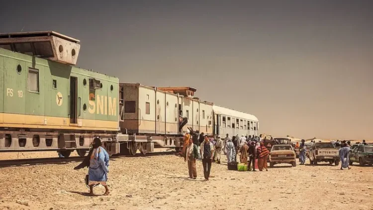 The train often stops in places where there is only desert around, and a flock of taxis are waiting for those who have arrived